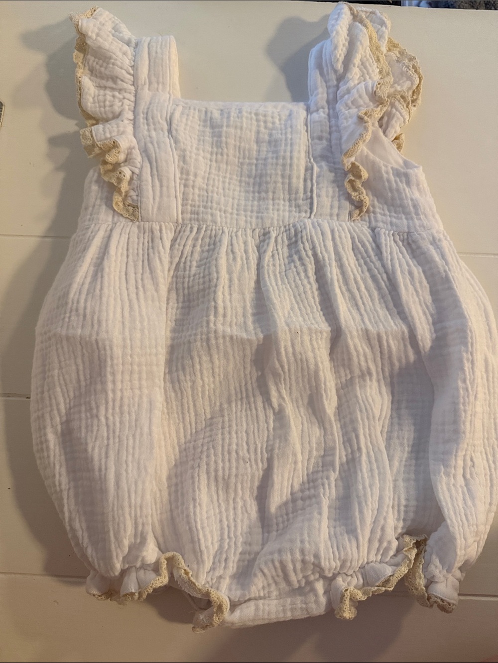 Sugar Kids White Romper with Subtle Blue and Yellow Logo